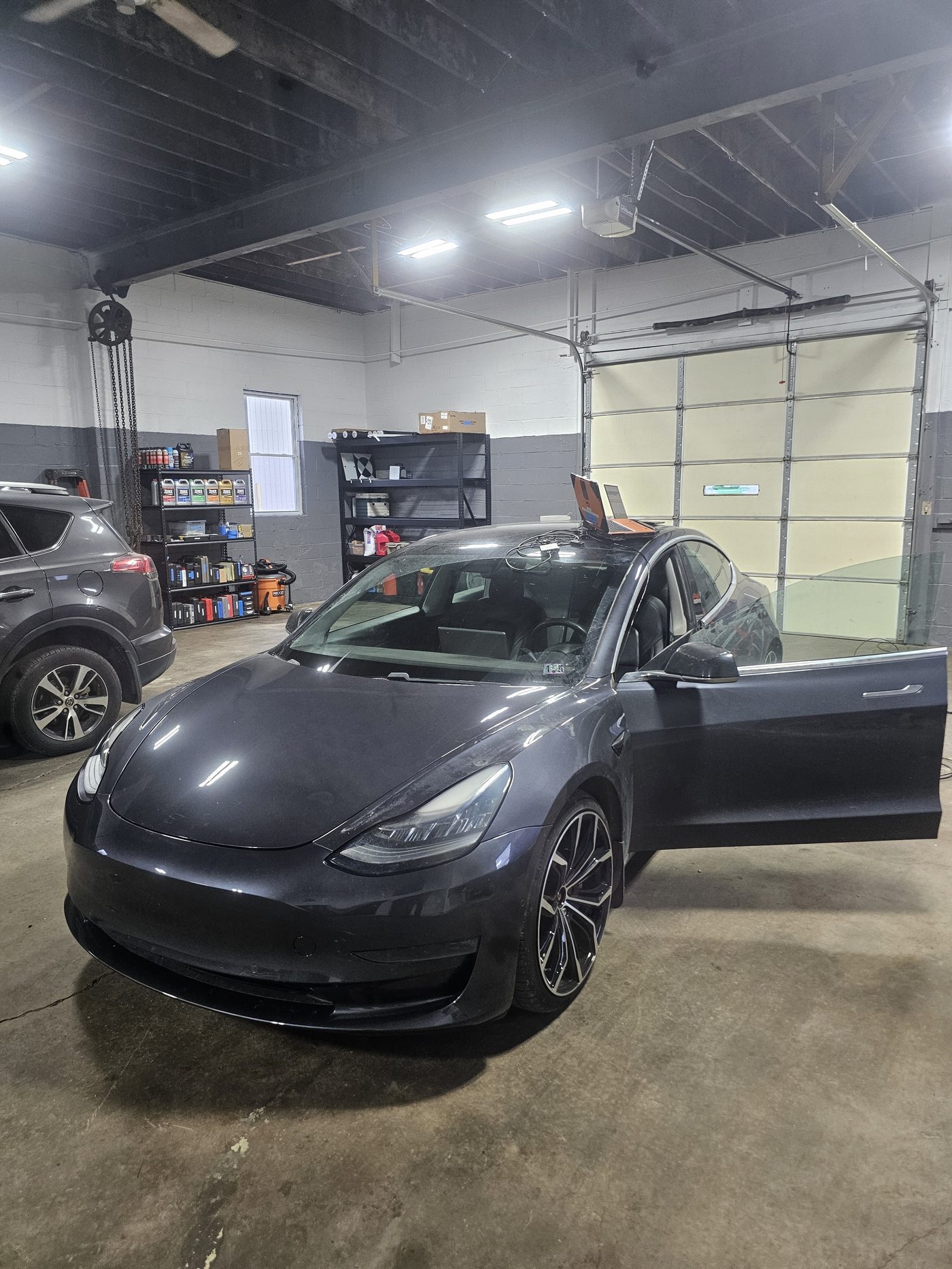 Tesla Model 3 in the diagnostics bay with a scan tool during electronic vehicle diagnostics