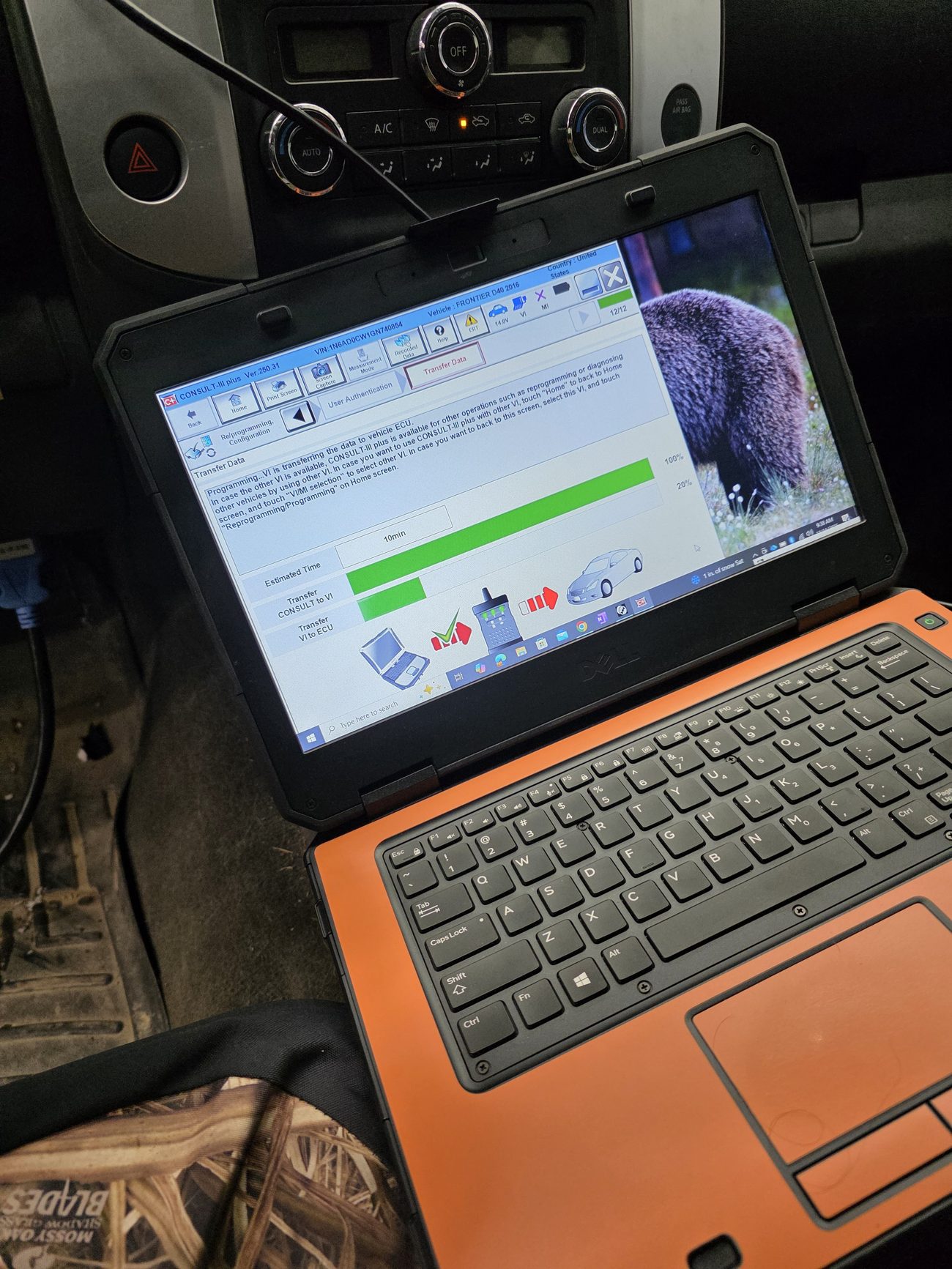 Rugged laptop reprogramming a vehicle control module inside a car