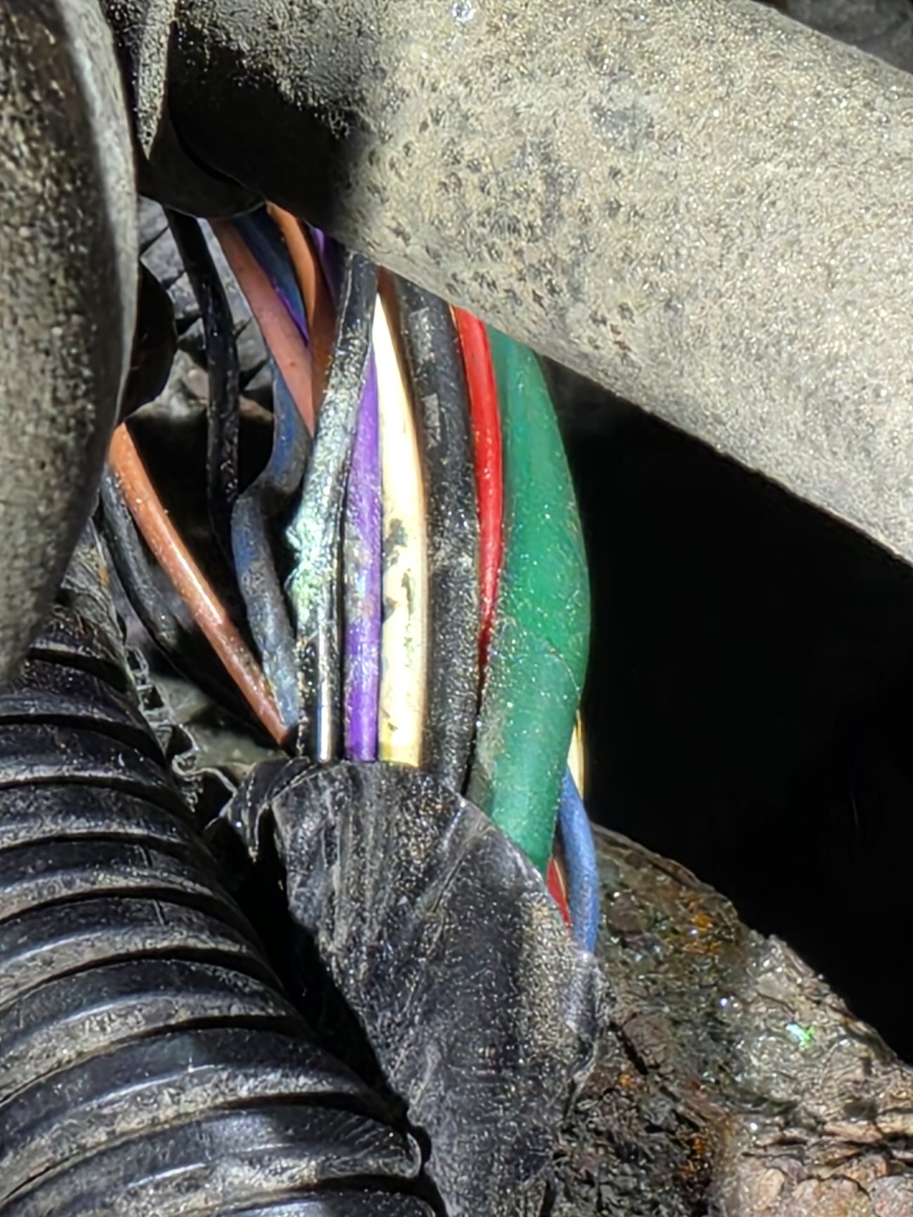 Automotive wiring harness bundle being inspected during vehicle network communication diagnostics